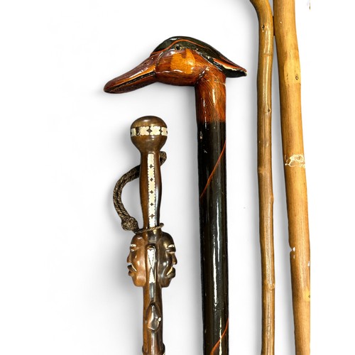 146 - A range of walking sticks to include a stick with mother of pearl inlay and carved double African he... 