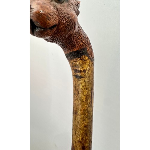 147 - A Brigg carved squirrel head walking stick with glass eyes, stamped Brigg. Length 92cm.