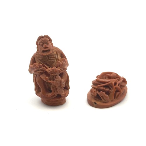 370 - A pair of Ojime netsuke beads, one of a seated man with a child (25mm high) and the other of mice am... 