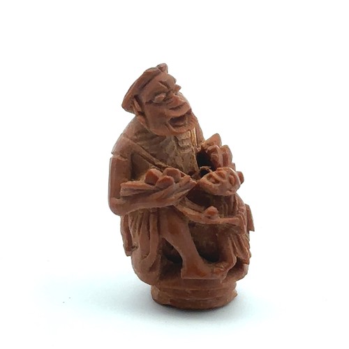 370 - A pair of Ojime netsuke beads, one of a seated man with a child (25mm high) and the other of mice am... 