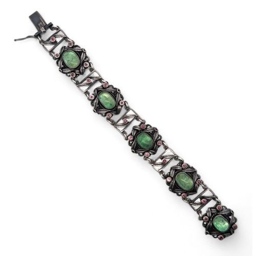 62 - An Arts and Crafts silver, green and pink stone bracelet. Stamped silver to clasp. Stones possibly t... 