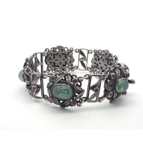 62 - An Arts and Crafts silver, green and pink stone bracelet. Stamped silver to clasp. Stones possibly t... 