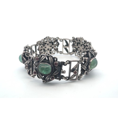 62 - An Arts and Crafts silver, green and pink stone bracelet. Stamped silver to clasp. Stones possibly t... 