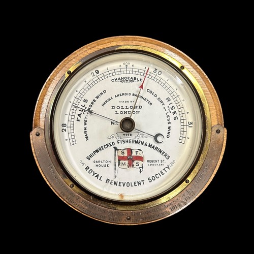 277 - Dolland London Marine Aneroid Barometer. Mid-twentieth century, oak cased with white ceramic dial. B... 