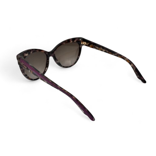 149 - A pair of modern Dior Sauvage purple and tortoise shell effect sunglasses with purple tinted lenses.... 