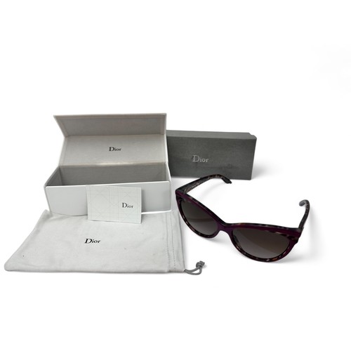 149 - A pair of modern Dior Sauvage purple and tortoise shell effect sunglasses with purple tinted lenses.... 