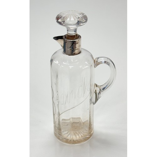 112 - An Edwardian silver and glass brandy jug. Body with ribbed effect and the word 'Brandy' cut into the... 