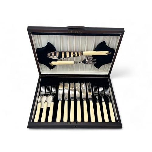 138 - A canteen of silver plated fish cutlery for six, marked RFM&S to blades, with faux ivory handles. Ho... 