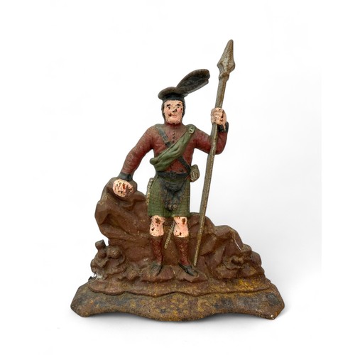 332 - A cast iron doorstop of a Scottish Highlander in uniform. Height 39cm, width 32cm.