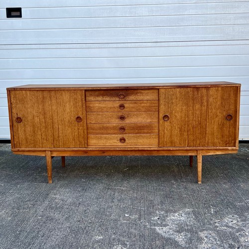 456 - Mid-century teak sideboard with two sliding doors and five central drawers, potentially Folke Ohlsso... 