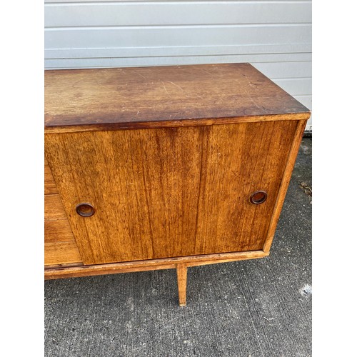 456 - Mid-century teak sideboard with two sliding doors and five central drawers, potentially Folke Ohlsso... 