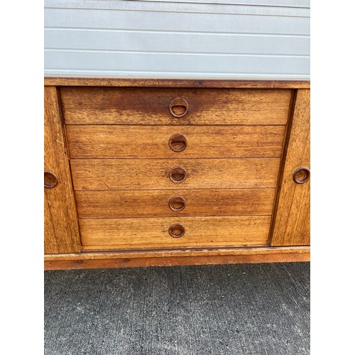 456 - Mid-century teak sideboard with two sliding doors and five central drawers, potentially Folke Ohlsso... 