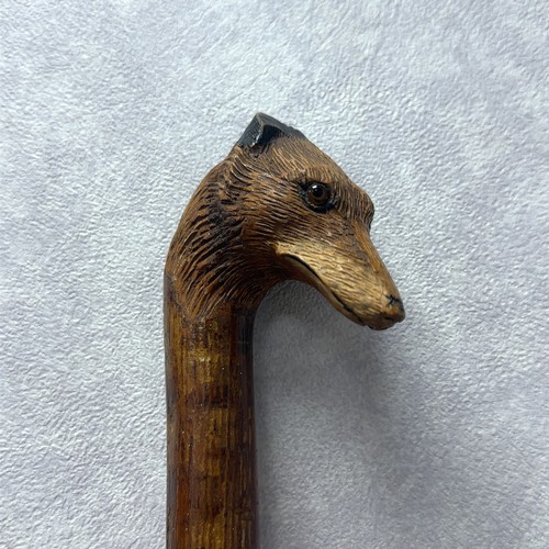 147A - A walking stick with the handle carved with the head of a fox with glass eyes, in the style of Swain... 