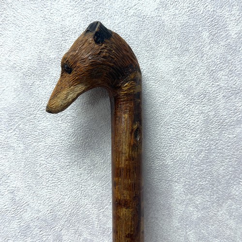 147A - A walking stick with the handle carved with the head of a fox with glass eyes, in the style of Swain... 