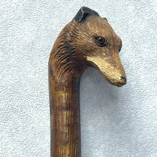 147A - A walking stick with the handle carved with the head of a fox with glass eyes, in the style of Swain... 