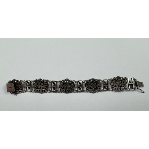 62 - An Arts and Crafts silver, green and pink stone bracelet. Stamped silver to clasp. Stones possibly t... 