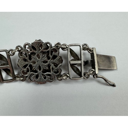 62 - An Arts and Crafts silver, green and pink stone bracelet. Stamped silver to clasp. Stones possibly t... 