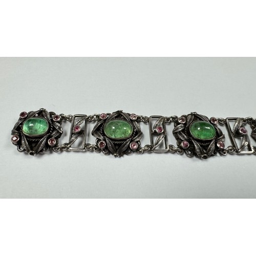 62 - An Arts and Crafts silver, green and pink stone bracelet. Stamped silver to clasp. Stones possibly t... 