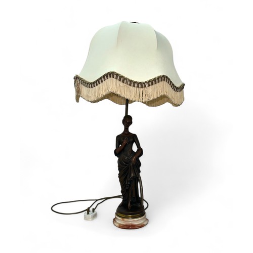 463A - An Art Deco Resin Lamp with a marble base of a Lady clutching a flower and her dress. Height measure... 