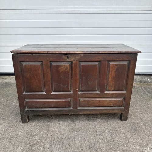 447 - Panelled Oak Coffer. With unhinged lid (lid has a crack). On four raised feet. BUYER TO COLLECT OR A... 