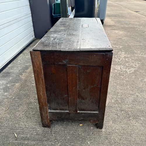 447 - Panelled Oak Coffer. With unhinged lid (lid has a crack). On four raised feet. BUYER TO COLLECT OR A... 