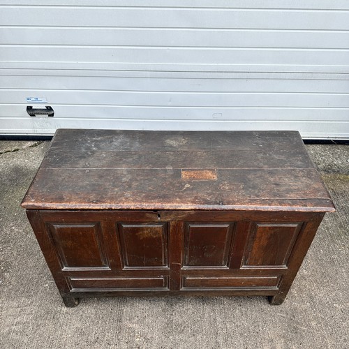 447 - Panelled Oak Coffer. With unhinged lid (lid has a crack). On four raised feet. BUYER TO COLLECT OR A... 