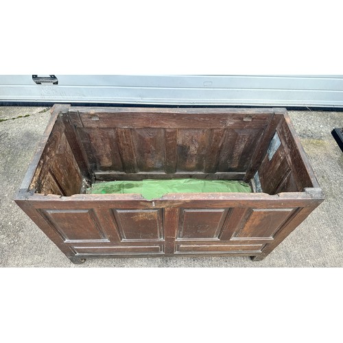 447 - Panelled Oak Coffer. With unhinged lid (lid has a crack). On four raised feet. BUYER TO COLLECT OR A... 