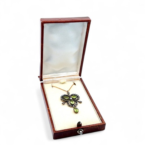 38 - A 9ct gold and silver vintage style necklace set with peridots, diamonds and a seed pearl. Chain 18