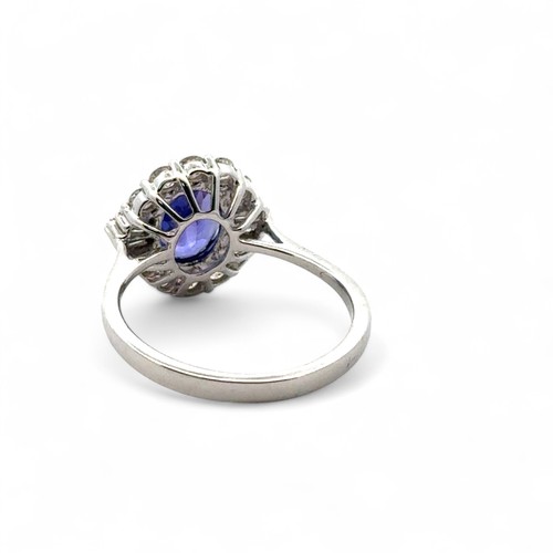 49 - A stunning tanzanite and diamond cluster ring, size N. The oval tanzanite of 1.54ct is surrounded by... 