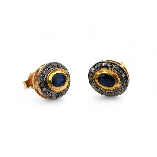 18 - A pair of oval sapphire and round cut diamond halo stud earrings, set in gold plated silver. Sapphir... 