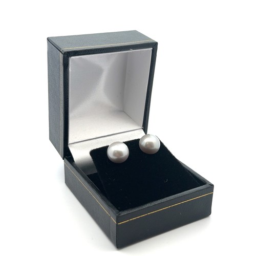 19 - A pair of 9ct yellow gold studs set with oblate spheroid grey cultured pearls.