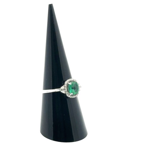 48 - An 18ct white gold emerald and diamond cluster ring with diamond shoulders, size N. Emerald approx 0... 