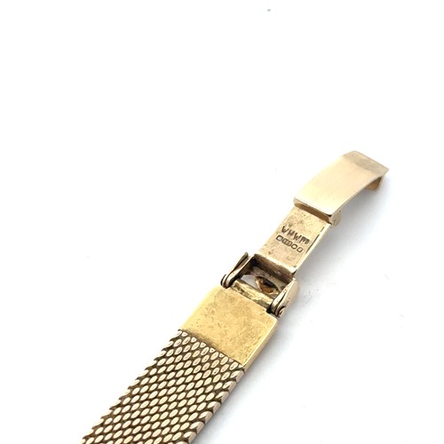 136 - Rolex - a ladies 14ct gold watch on a 14ct gold bracelet. Rounded square champagne dial with gold to... 