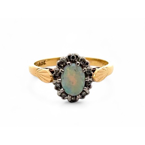 5 - An opal and diamond cluster ring, stamped 18ct. Size L. Some wear and small chip to opal. 3.9g.