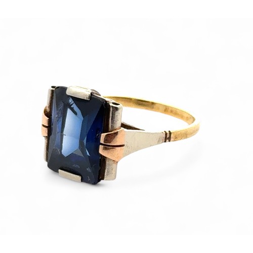 60 - A synthetic sapphire ring in unmarked yellow metal, tested as 18ct gold using XRF. Large chip to the... 