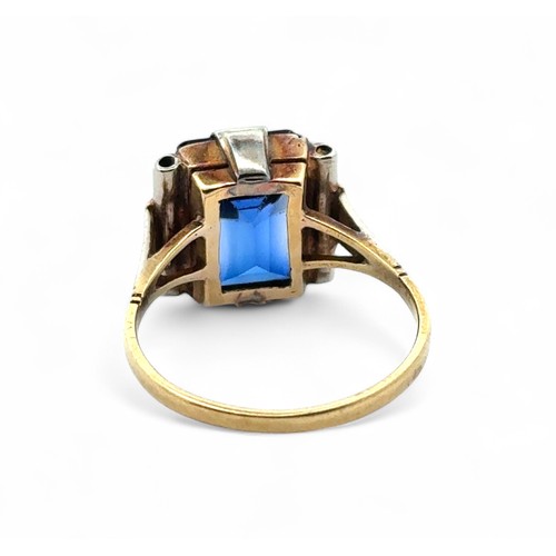 60 - A synthetic sapphire ring in unmarked yellow metal, tested as 18ct gold using XRF. Large chip to the... 