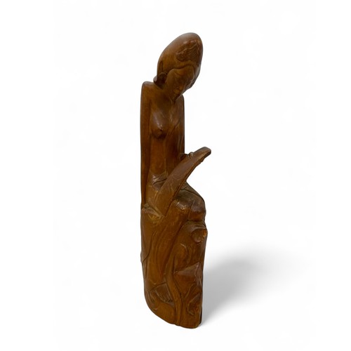 345 - Balinese carved wooden sculpture of a seated lady signed IWAJANWIRI MAS BALI to base. Height 37cm.