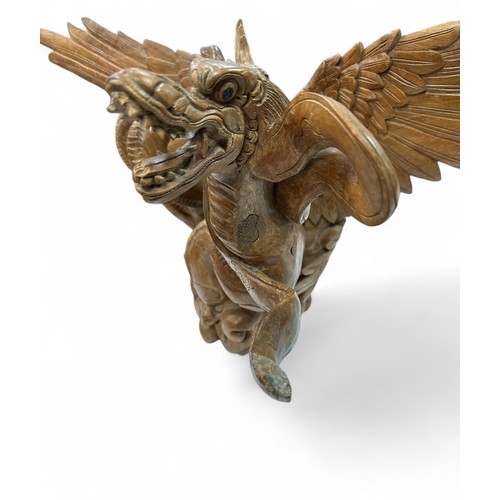 321 - Large impressive wooden sculpture of an eagle and dragon. Some damage but still a dramatic piece. He... 