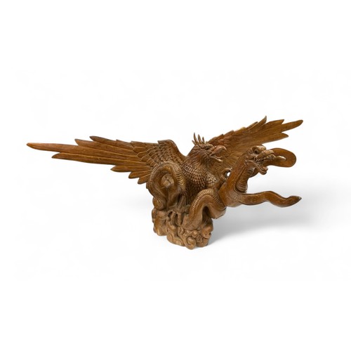 321 - Large impressive wooden sculpture of an eagle and dragon. Some damage but still a dramatic piece. He... 