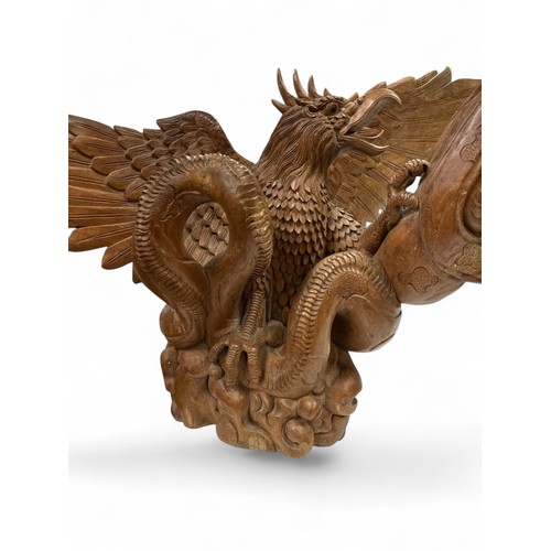 321 - Large impressive wooden sculpture of an eagle and dragon. Some damage but still a dramatic piece. He... 