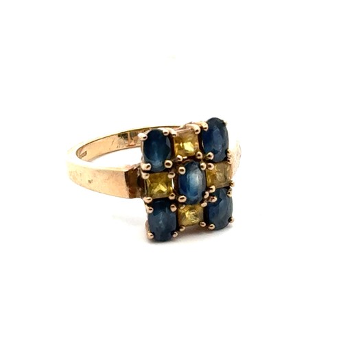 35 - A blue and yellow sapphire checkerboard 9ct gold ring, size N. Weight 3.9g.