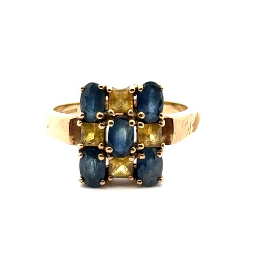 35 - A blue and yellow sapphire checkerboard 9ct gold ring, size N. Weight 3.9g.