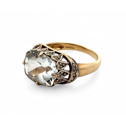 80 - A 9ct topaz ring with a white stone set gallery and shoulders, size N. Sponsor DK. Weight 4.24g.