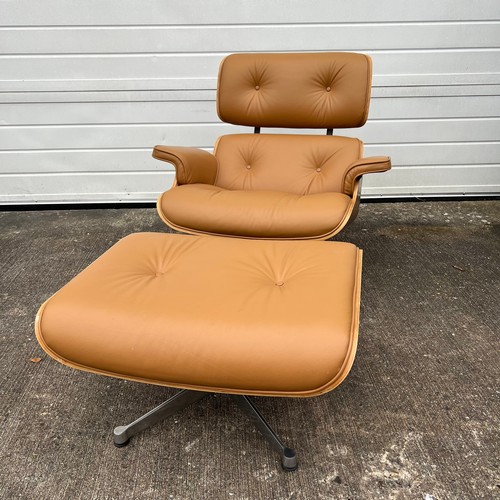 445 - After Charles and Ray Eames lounge chair and ottoman, beige / cream leather and moulded plywood with... 