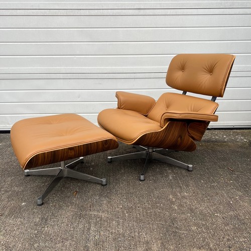 445 - After Charles and Ray Eames lounge chair and ottoman, beige / cream leather and moulded plywood with... 