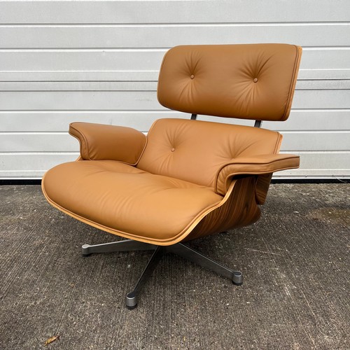 445 - After Charles and Ray Eames lounge chair and ottoman, beige / cream leather and moulded plywood with... 