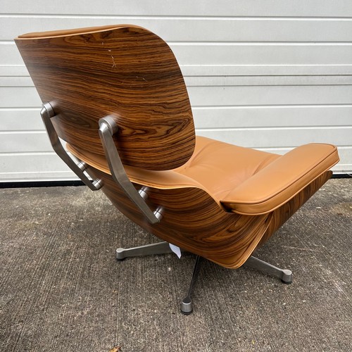 445 - After Charles and Ray Eames lounge chair and ottoman, beige / cream leather and moulded plywood with... 