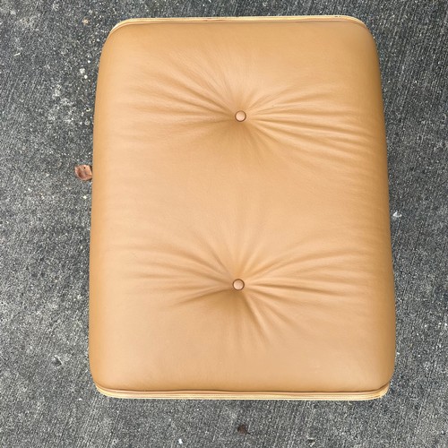 445 - After Charles and Ray Eames lounge chair and ottoman, beige / cream leather and moulded plywood with... 