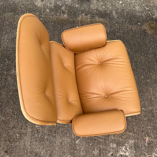 445 - After Charles and Ray Eames lounge chair and ottoman, beige / cream leather and moulded plywood with... 