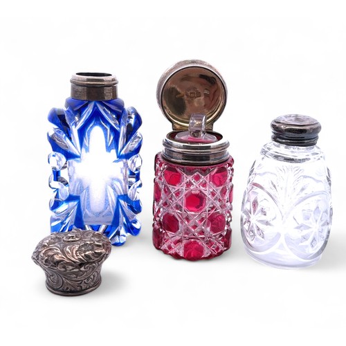 154 - Three glass scent bottles. Includes a Sampson & Mordan cranberry glass bottle with silver mount and ... 